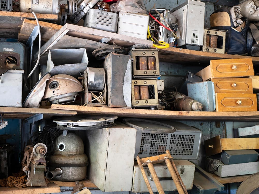 shelves of vintage equipment and things in abandoned garage clutter