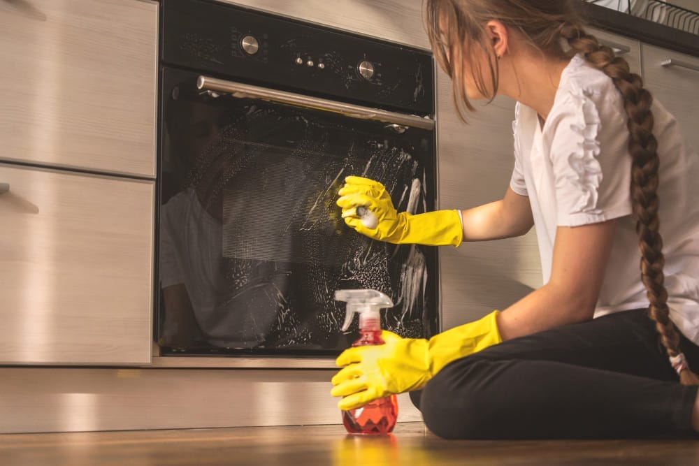 woman cleaning kitchen example